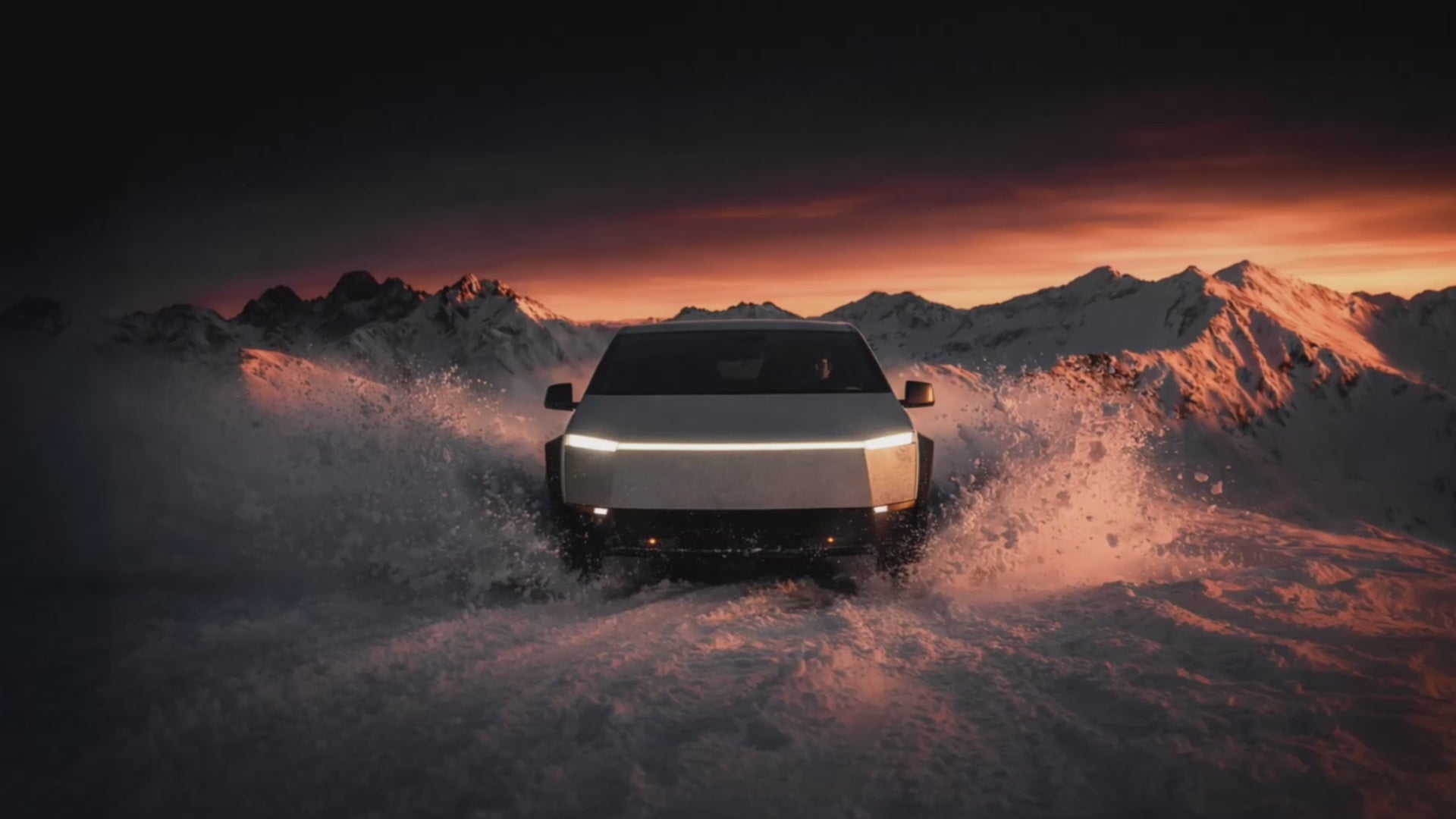 A futuristic, stainless steel electric truck aggressively plows through deep snow