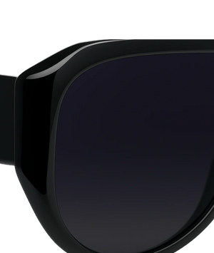 Close-up of a black sunglasses with a white background