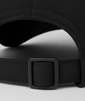 Close-up of a black cap with a buckle on a light gray background