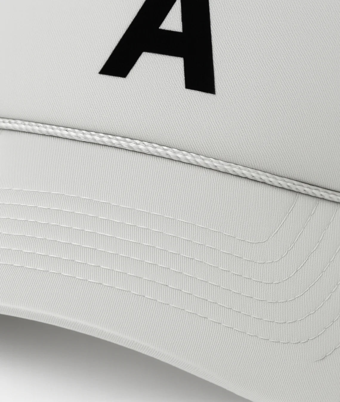 White cap with a black letter 'A' on a light gray background