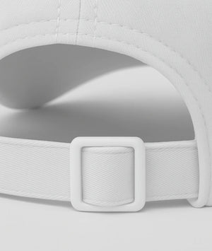 Close-up of a white cap with a buckle on a light gray background