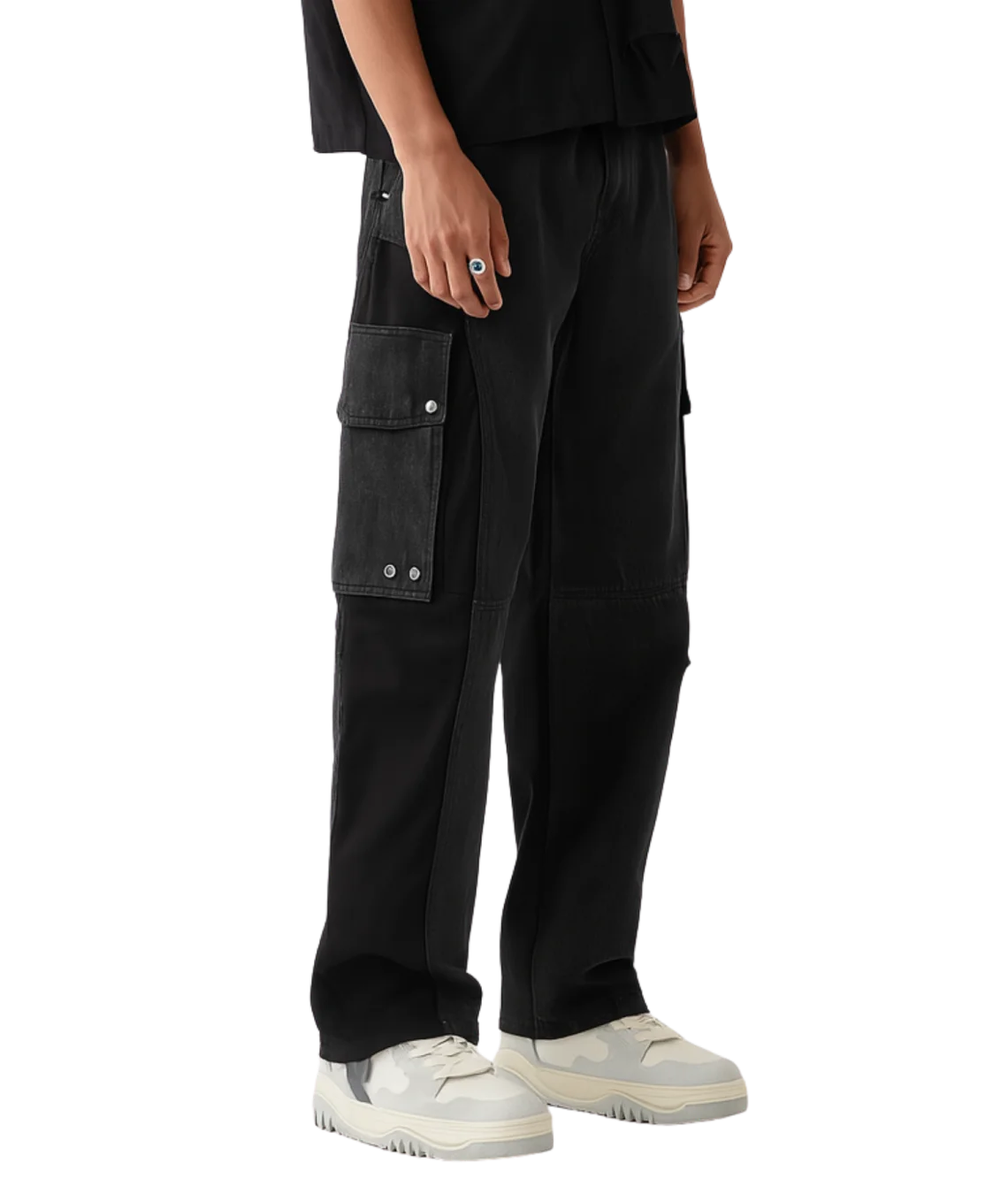 Person wearing black cargo pants on a white background