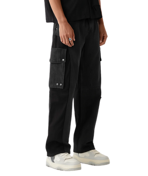 Person wearing black cargo pants on a white background