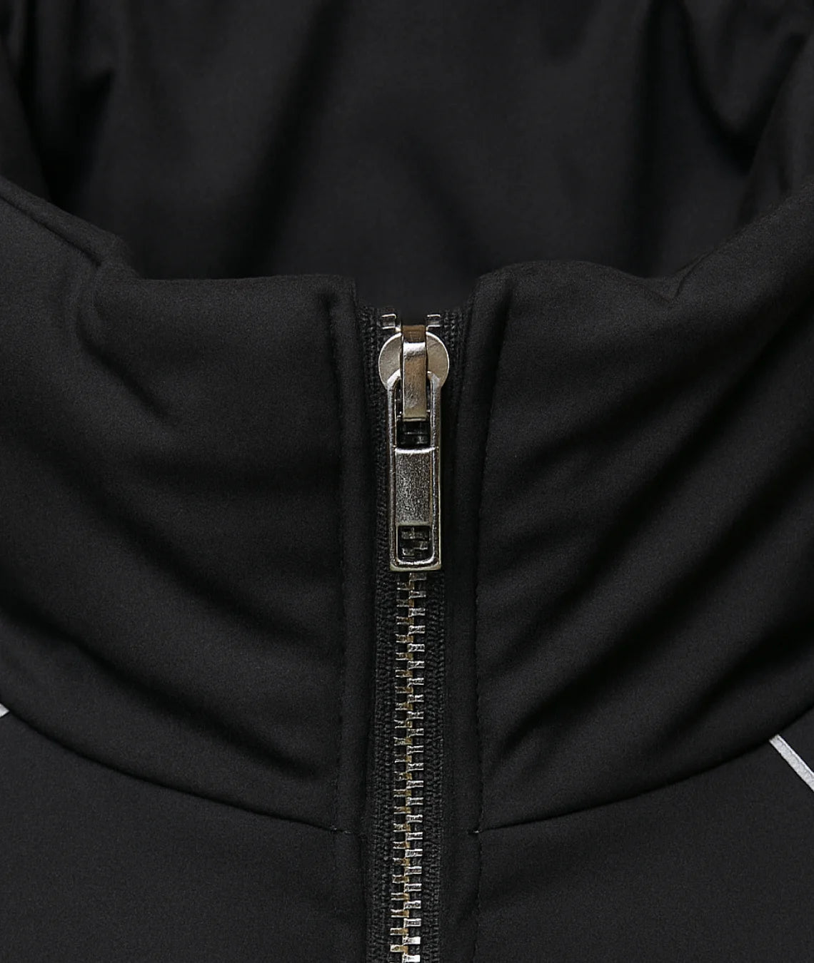 Close-up of a black jacket zipper with metallic finish