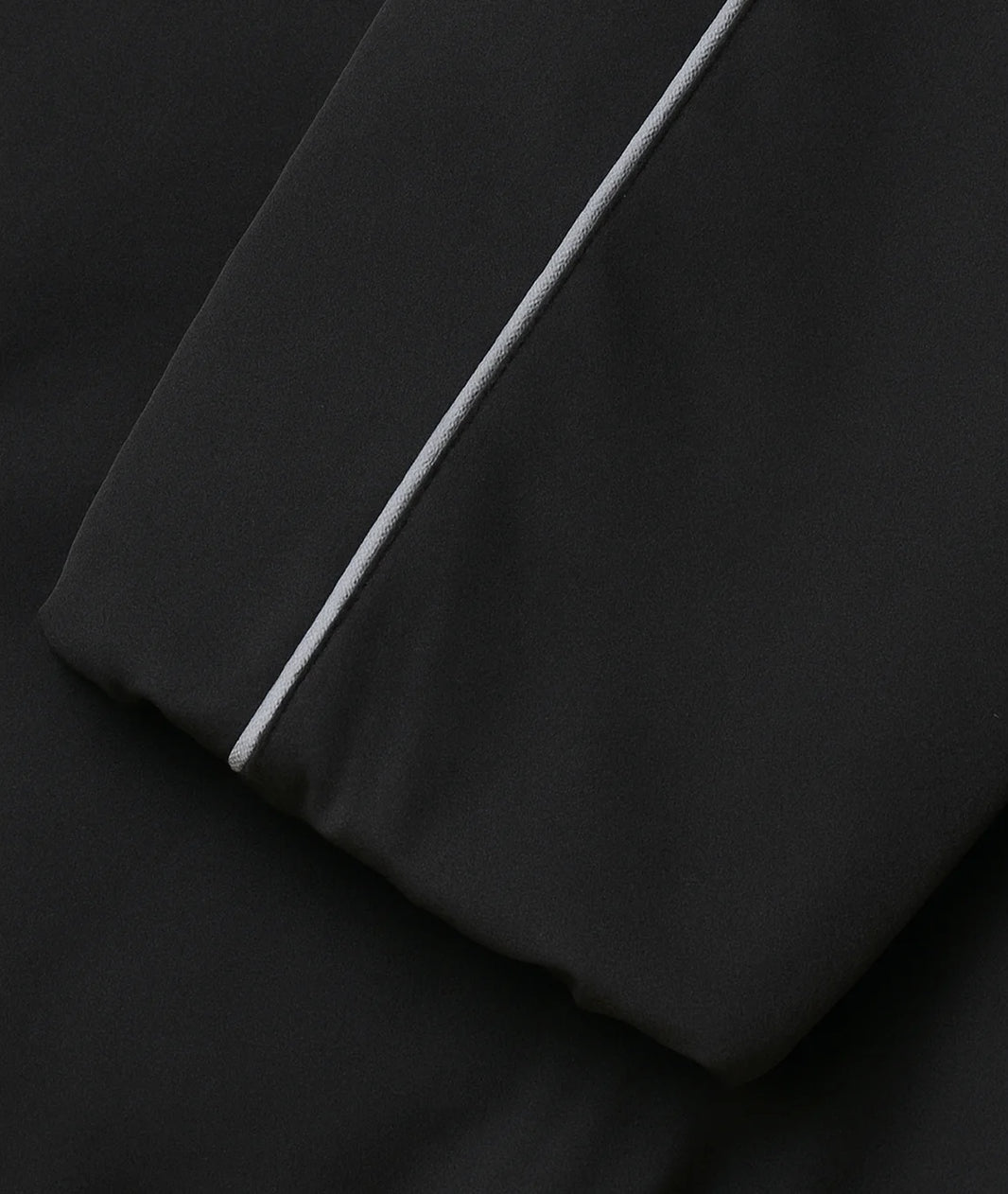 Black fabric with a white stripe on a black background