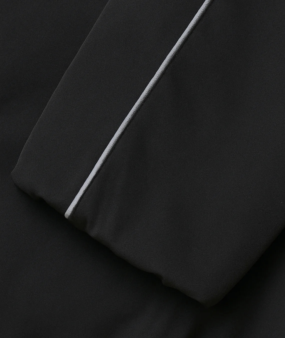 Black fabric with a white stripe on a black background