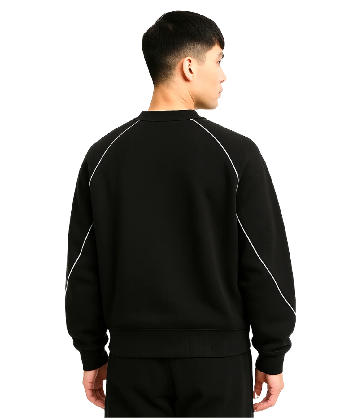 Person wearing a black tracksuit with white piping on a white background
