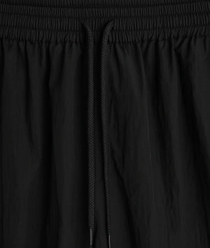 Close-up of black pants with a focus on the waistband and fabric texture.