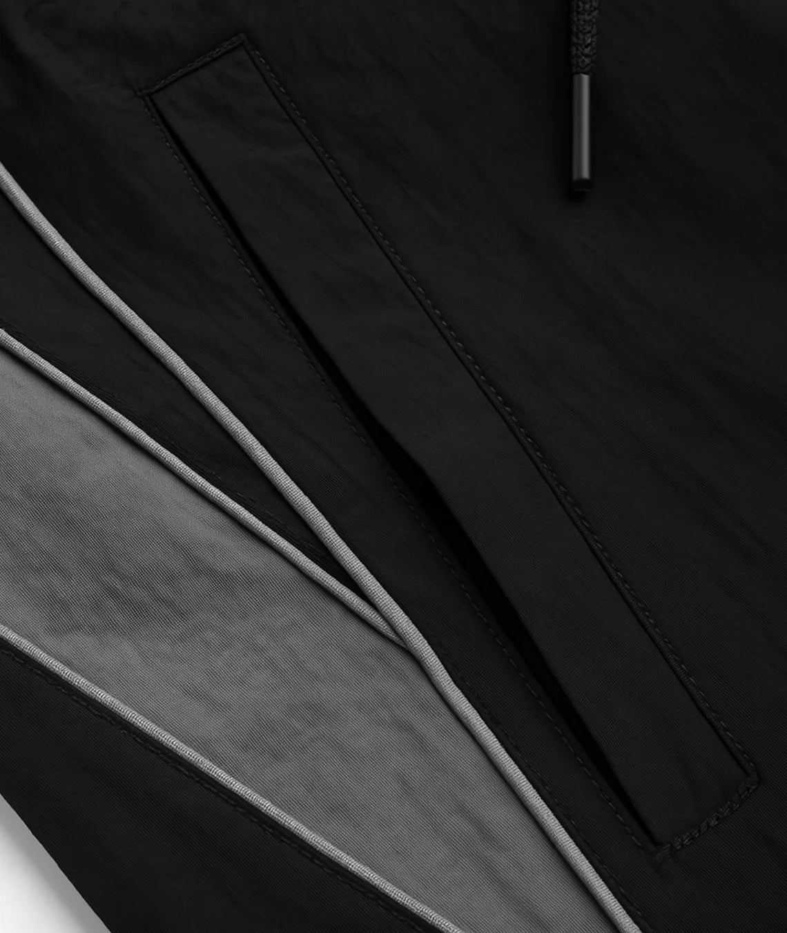 Close-up of a black jacket with a zipper detail on a dark background