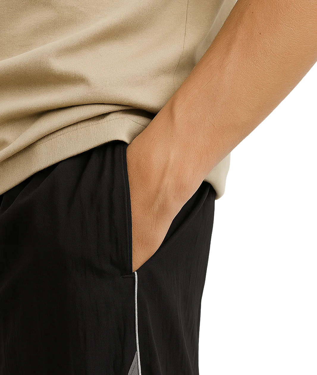 Person wearing a beige sweater and black pants with a white stripe.