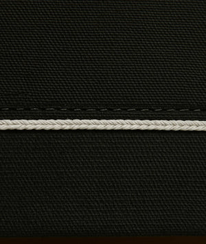 Close-up of black fabric with a white stitching detail