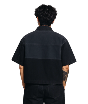 Person wearing a black short-sleeve shirt on a white background