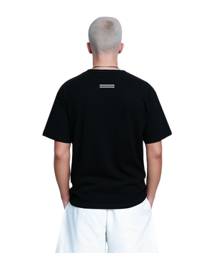 Person wearing a black t-shirt with a logo on the back against a white background