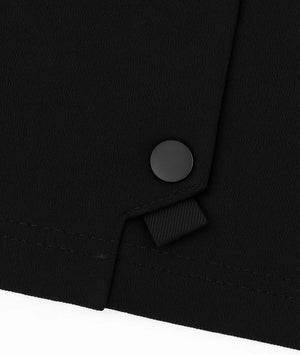 Close-up of a black button on a black garment