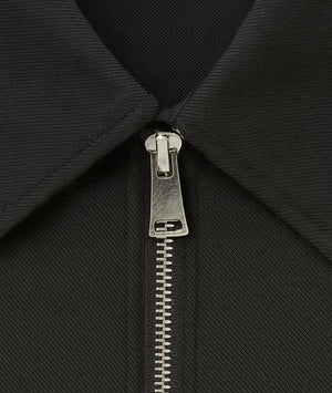 Close-up of a black jacket with a silver zipper