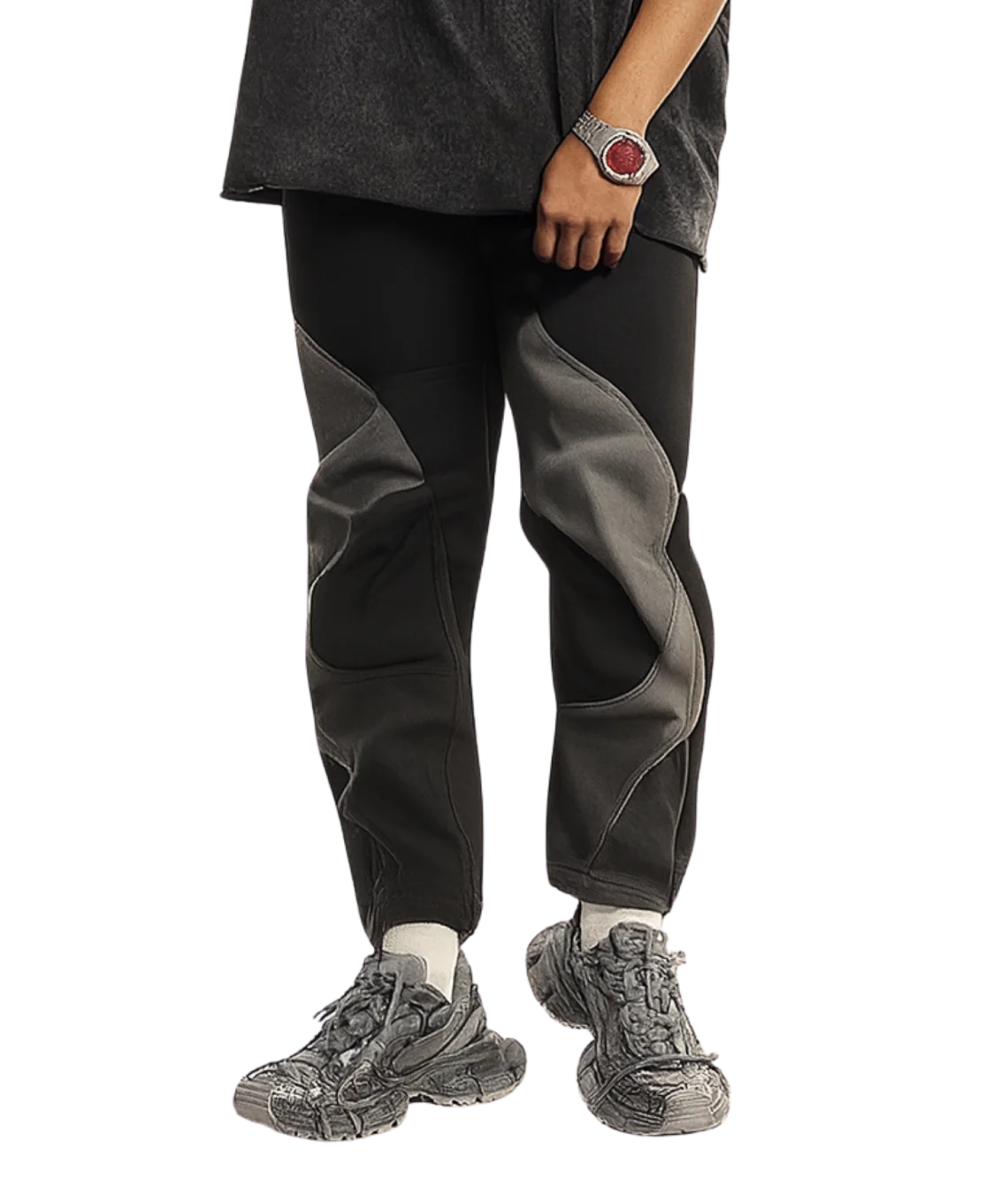 Person wearing black and gray pants with hiking shoes on a white background