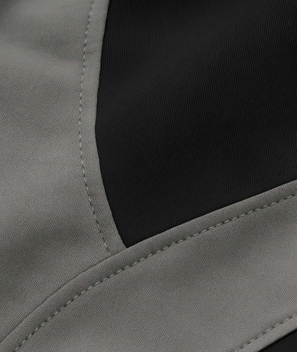 Close-up of a gray fabric with a black section, possibly from a jacket or coat.