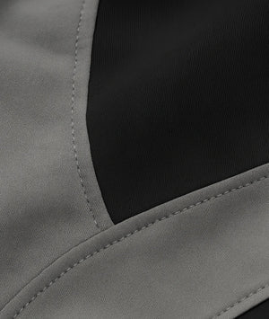 Close-up of a gray fabric with a black section, possibly from a jacket or coat.