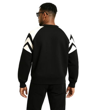 Person wearing a black and white outfit with geometric patterns on a transparent background