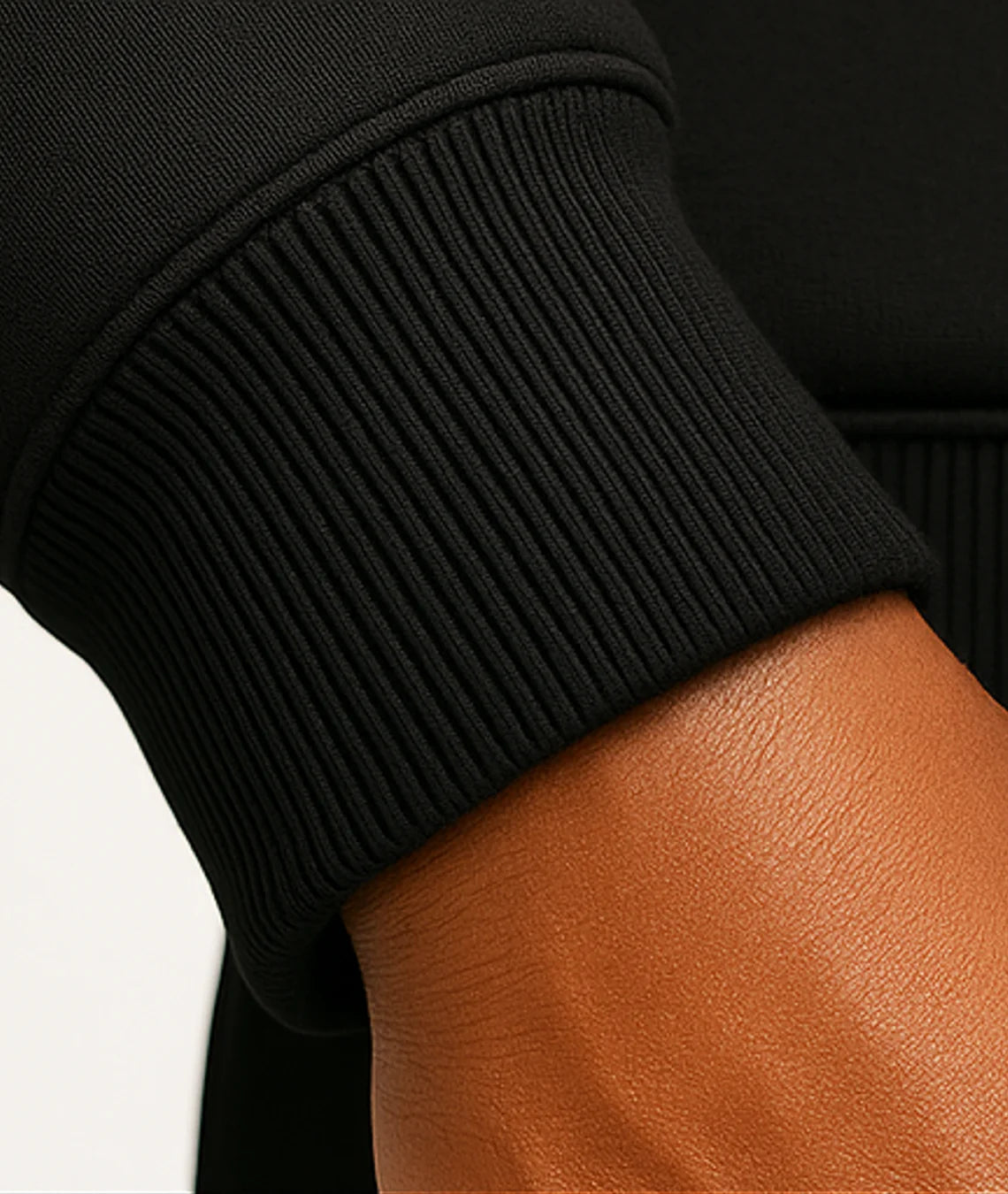 Close-up of a person wearing a black sleeve with a white background