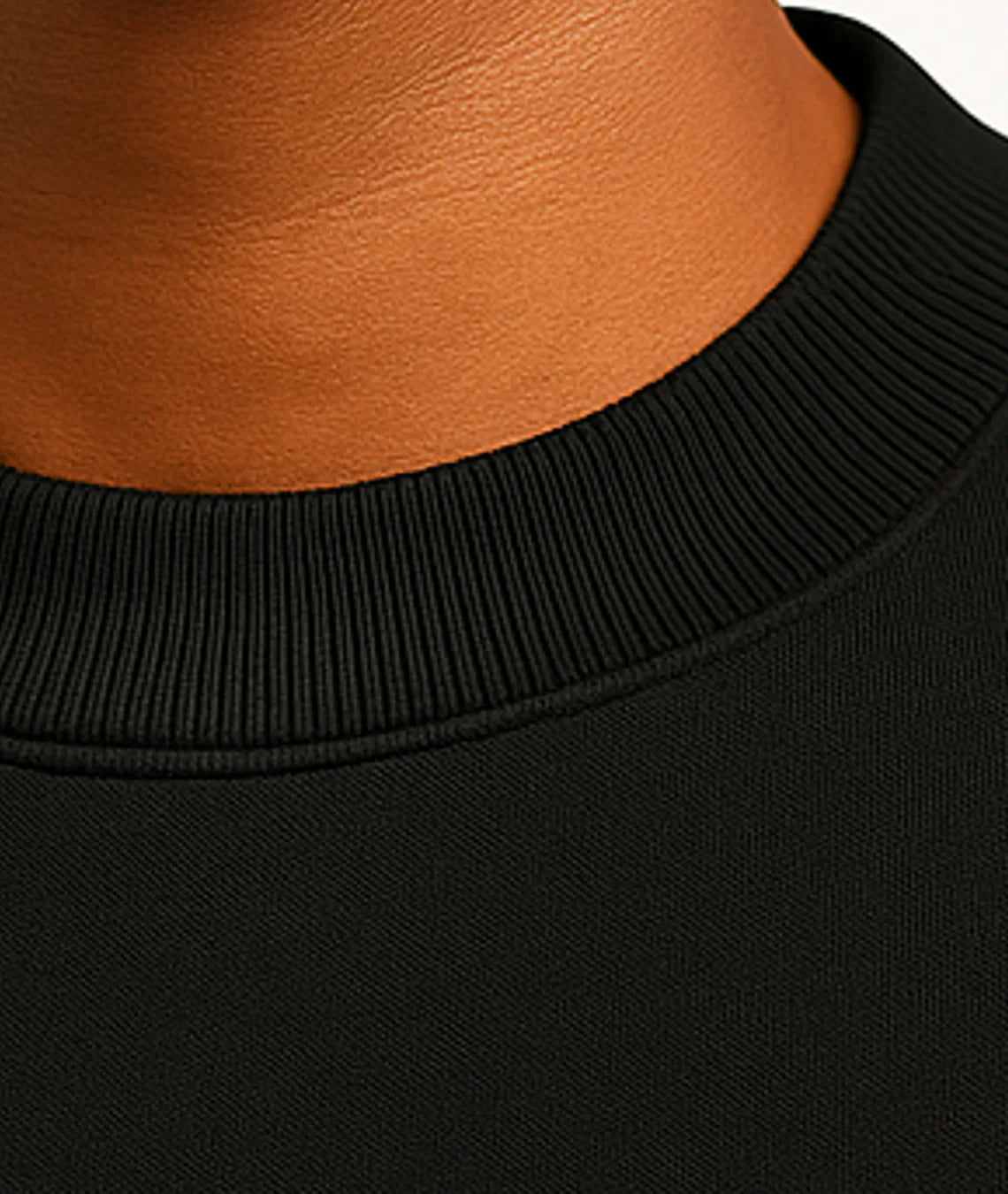 Close-up of a black garment with a brown collar.