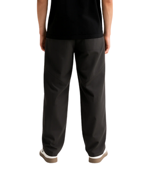 Person wearing black pants on a white background