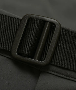 Close-up of a black belt with a buckle on a dark background