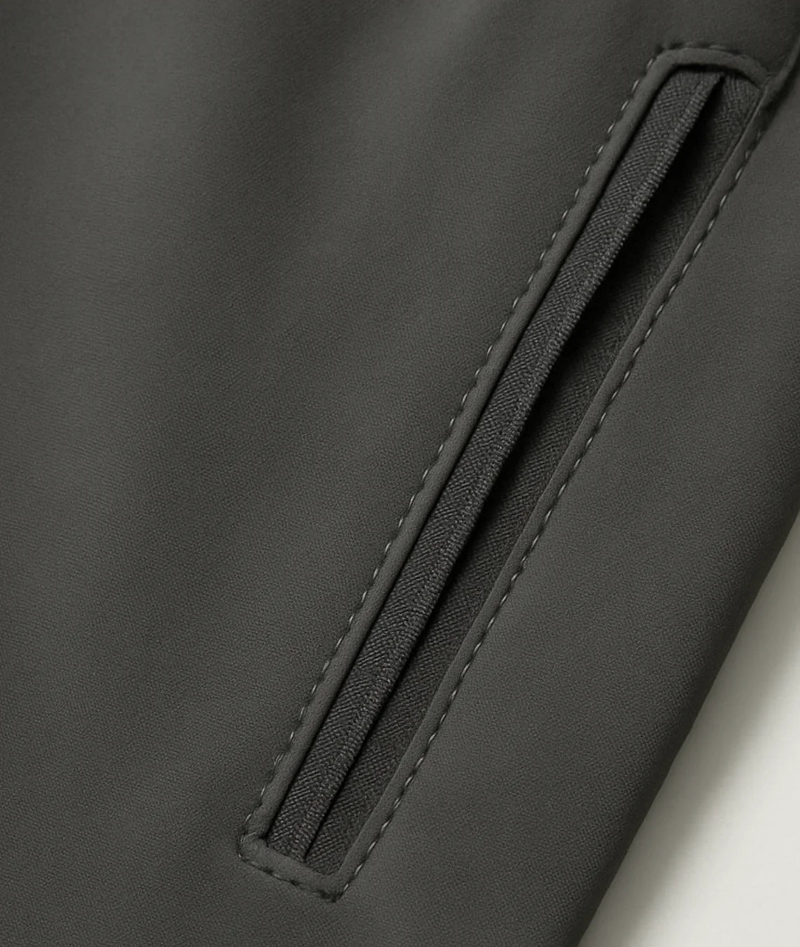Close-up of a black jacket with a zipper detail on a white background