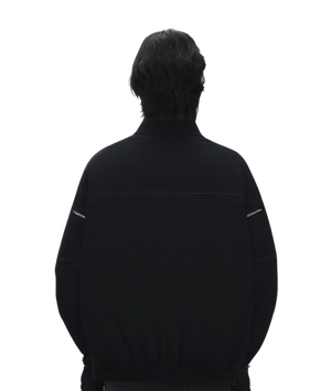 Person wearing a black jacket on a white background