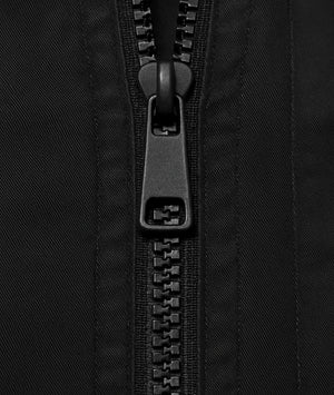 Close-up of a black zipper on black fabric