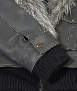 Close-up of a gray jacket with fur lining and black ribbed cuffs.