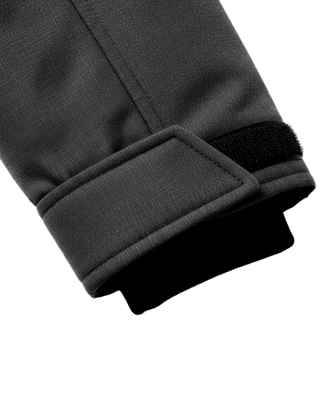 Close-up of a black jacket sleeve with a white background