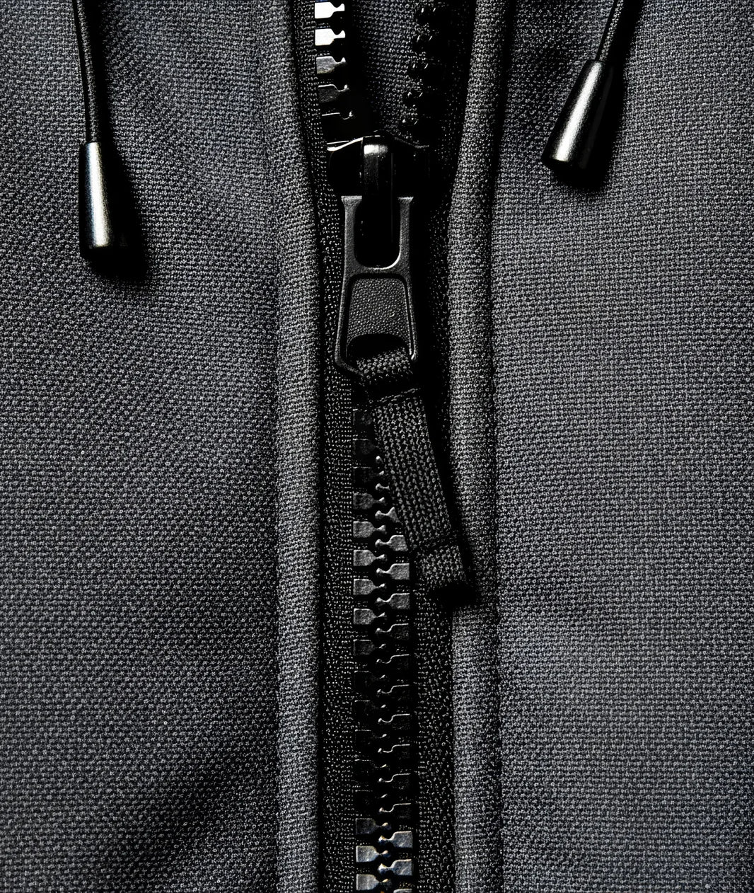 Close-up of a black zipper on a gray fabric background