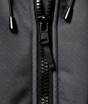 Close-up of a black zipper on a gray fabric background