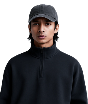 Person wearing a black turtleneck sweater and gray cap on a white background