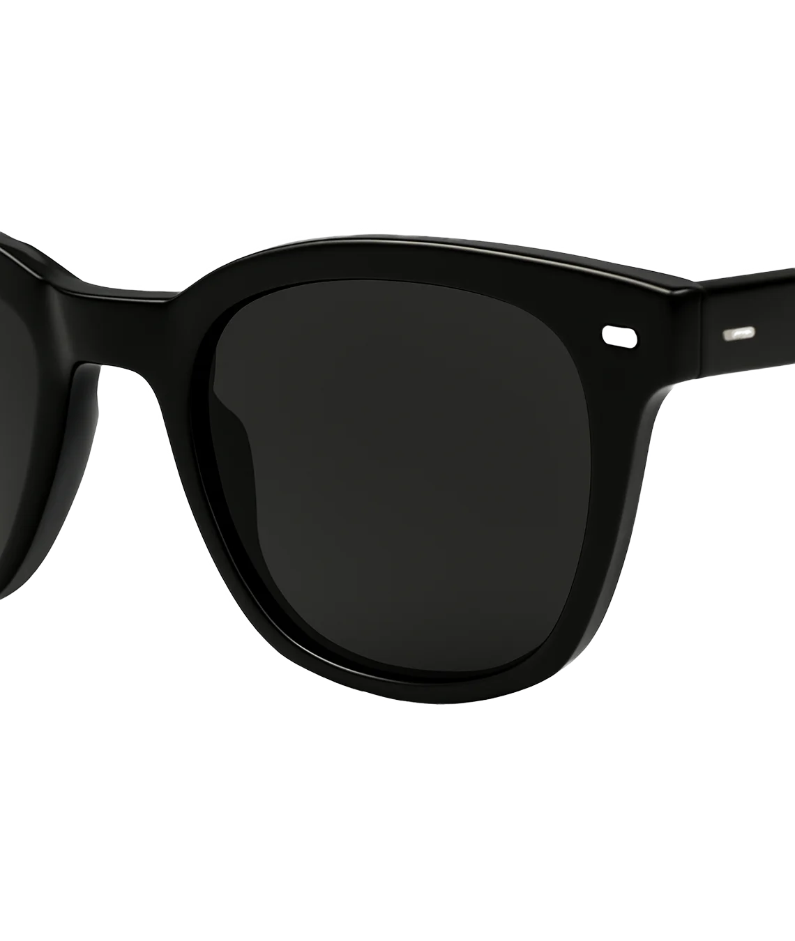 Close-up of a pair of sunglasses with a thick black acetate frame and dark tinted lenses, shown against a plain white background.