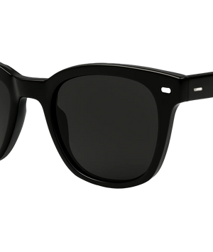Close-up of a pair of sunglasses with a thick black acetate frame and dark tinted lenses, shown against a plain white background.