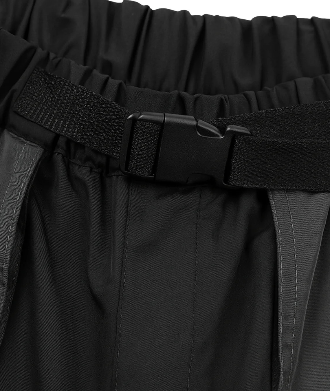 Black pants with a belt and visible brand logo on a dark background