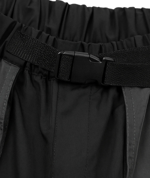 Black pants with a belt and visible brand logo on a dark background