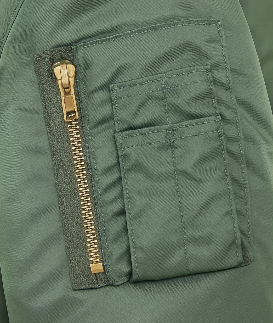 Green jacket with a gold zipper and pocket