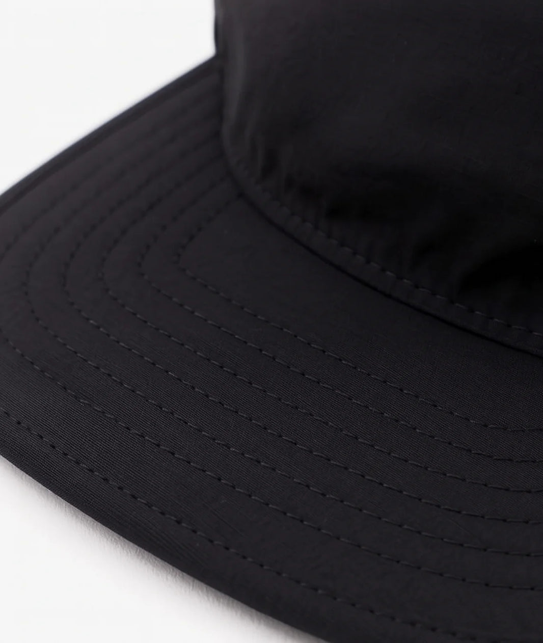 Close-up of a black bucket hat on a white background