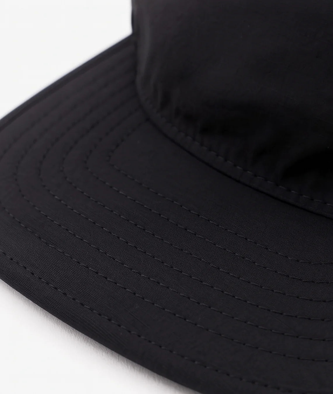 Close-up of a black bucket hat on a white background
