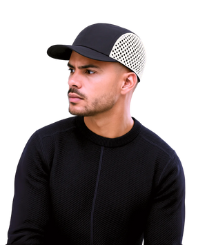 Man wearing a black cap with a white pattern on a white background