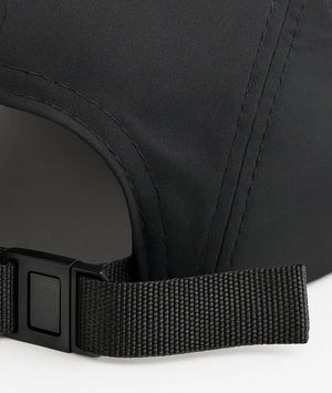 Close-up of a black cap with a strap on a white background