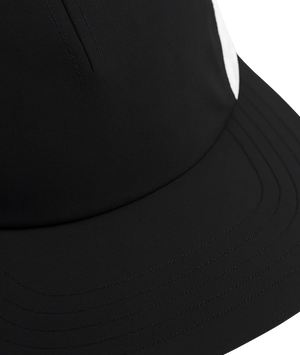 Close-up of a black cap with a white background