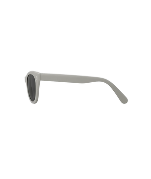 A pair of sunglasses with a matte light gray frame and dark gray lenses, shown from a side profile view on a solid white background.