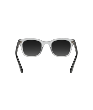 A pair of square sunglasses with a translucent clear acetate frame and dark gray gradient lenses, shown from the front on a solid white background.