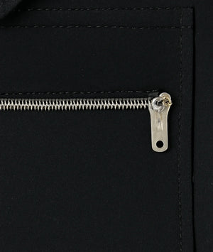 Close-up of a zipper on a black leather bag