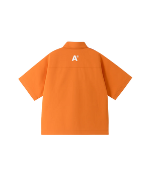 Orange shirt with a logo on the back against a white background
