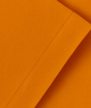 Close-up of orange fabric with a visible seam